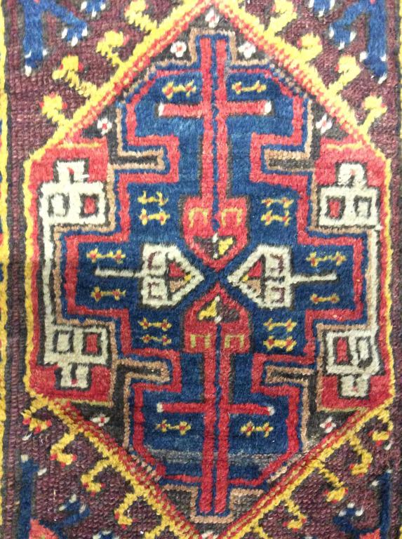 Handmade Antique Wool Rug: Rug is handmade & wool. Piece contains intricate multi toned geometric detail. Wool rug, handmade rug, antique rug. Piece appears to have been cut in some areas, contains evident wear. Piece measures 