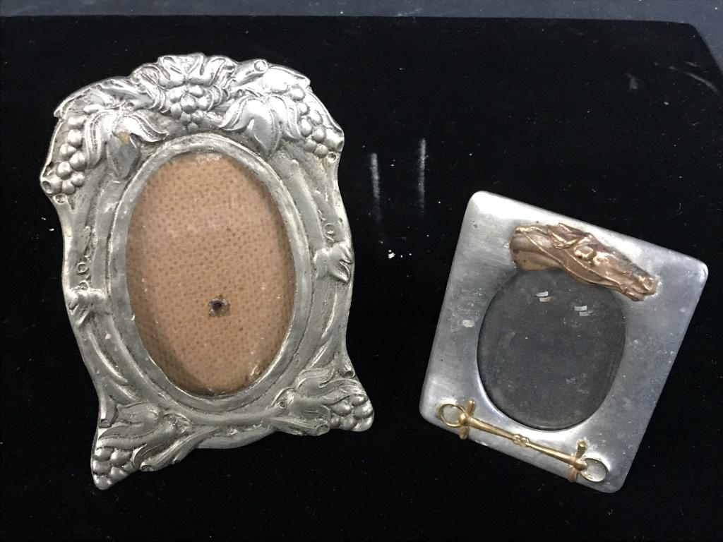 Lot 2 Vintage Pewter & Plated Table Picture Frames: Art Nouveau Pewter Metal With Grape vine motif in relief. 2 3/4 x 1 3/4 in. oval opening. Frame is 5 x 3.5 in. Horse Motif Copper in Relief on silver plate. Frame measures 3 1/4 x 2.5 in. with 2 1/8 x