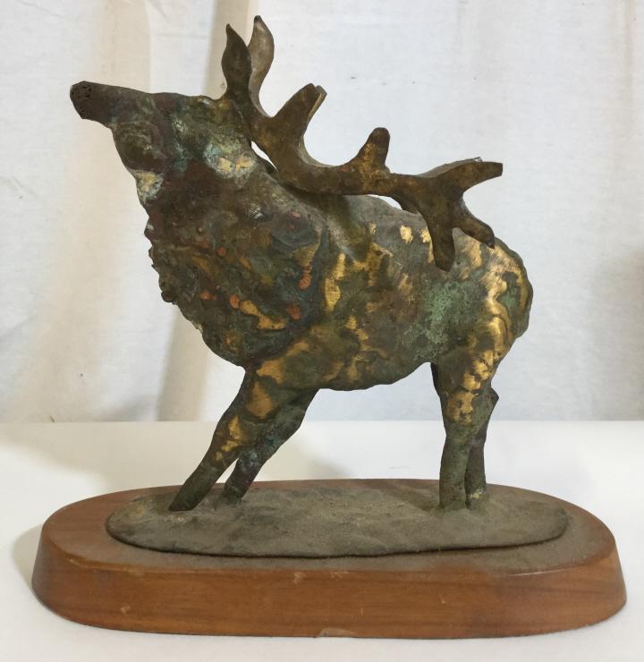 Metal Elk Statuette W Wood Base: Moose / elk / deer statuette, cast metal mounted on a wooden base, possibly vintage. The piece measures approx 8.5 inches H, and 9 inches W. Some wear is present due to age. Statuettes, ornamental, Fi