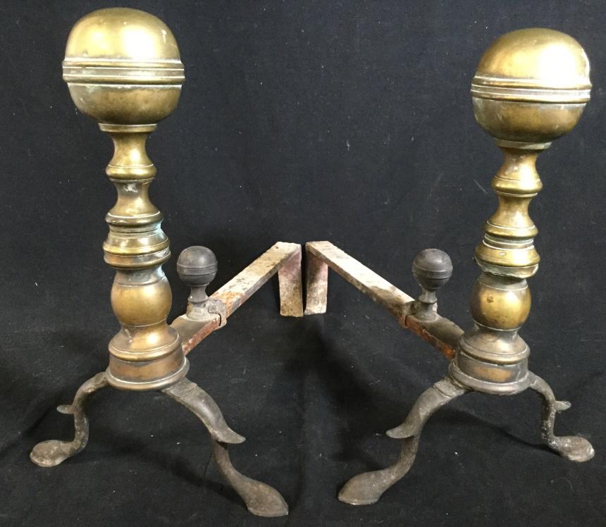 Antique Brass and Iron Ball Topped Andirons: Pair of brass and iron Andirons. Pieces are attributed to John Molineux. Each piece measures approx 14.12 inches H, 9.8 inches W, and 16.75 inches long. Wear is present on piece due to use. Andirons, 