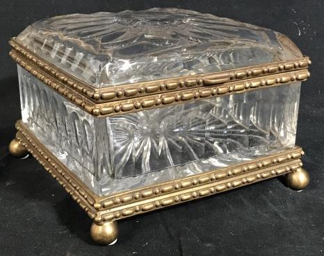 CASTILIAN Glass Crystal and Brass Jewelry Box: CASTILIAN Crystal glass and brass jewelry box. The piece is scalloped along the top and sides, has a hinged lid and brass ball feet. The piece measures approx 5.5 inches H and 7.5 inches W. Crystal, t
