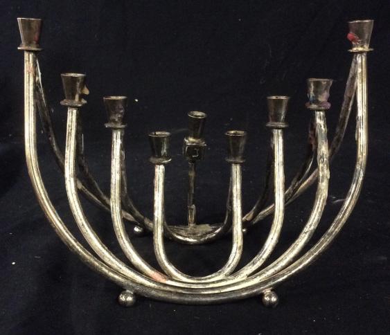 Vintage Wainberg silver toned menorah: Silver toned possibly silver plated vintage menorah. Bottom reads Wainberg. Detachable dreidle, Measures approximately 7.5 inches wide and 6.5 inches tall. Menorah, holidays, vintage menorah, collecti