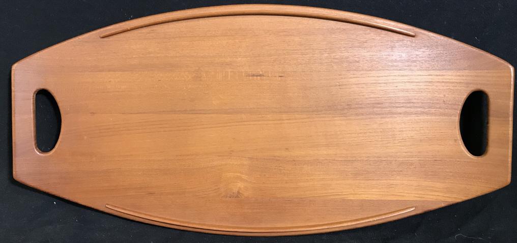 Vintage DANSK Jens Quistgaard Teak Tray: Vintage DANSK Jens quistgaard teal tray. The piece is crafted from teal wood. Runners on the underside of the tray provide support, separating the tray from whatever surface it comes in contact with.