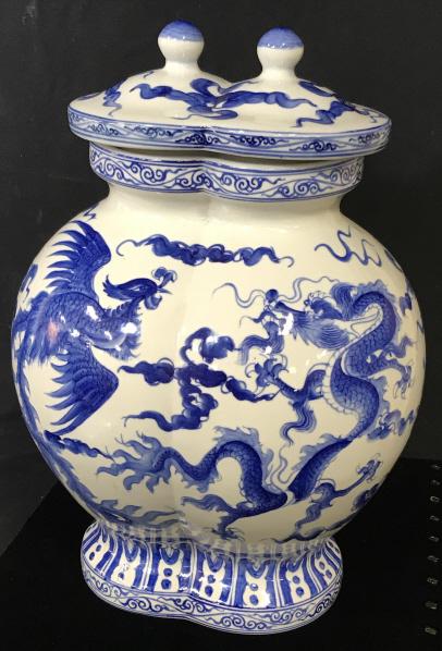 Large Japanese Porcelain Dragon-ware Ginger Jar: Blue & White Dragon Motif Vase with Lid. Underside has sticker in red with diamond shape logo and Japanese / Asian character writing. Measures 14 in. Ht. 10 in. width, 7.5 in. depth. Lid has a slight
