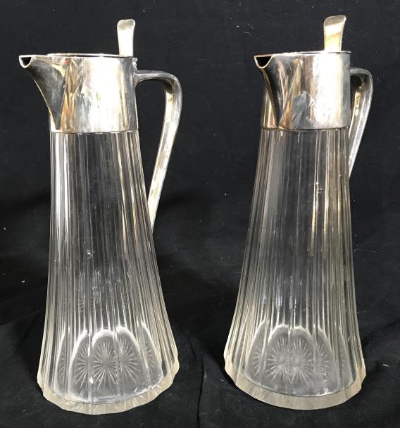 Set 2 ART KRUPP BERNDORF Glass Pitchers: Set of 2 vintage, possibly antique, ART KRUPP BERNDORF Glass pitchers. The lids and handles are silver plated. Each piece measures approx 10.25 inches tall, and 4.6 inches W. Wear. Present on the piec