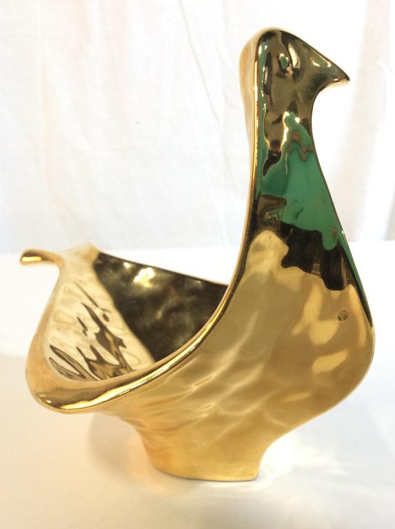 JONATHAN ADLER Gold Toned Dove Dish: Underside of piece is marked JONATHAN ADLER. Piece is gold toned and resembles shape of dove. Piece measures approx 8 inches long 6 inches tall, 4.5 inches wide. porcelain, collectible, designer home
