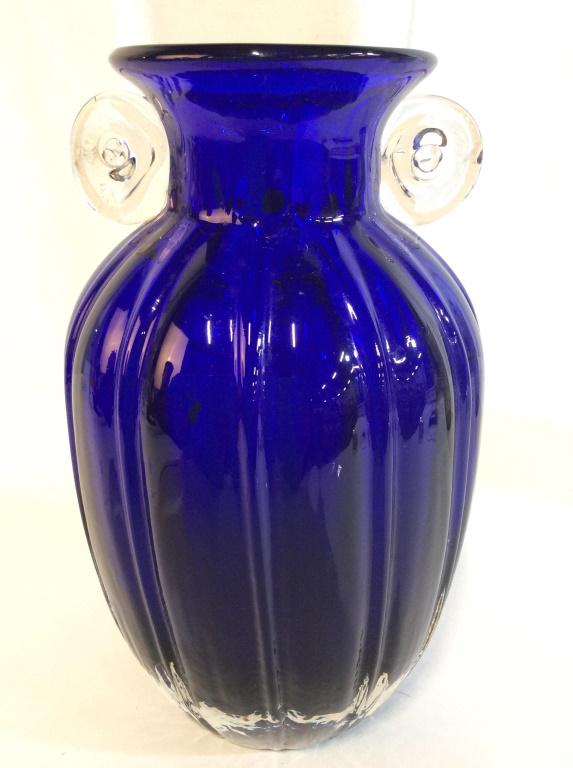 Cobalt Blue Thick Art Glass Vase: Vase is cobalt blue toned. Contains 2 clear glass handles. Vase, glass vase, art glass vase, centerpiece. decorative tabletop accessory, shelf peice, decorative tableware, home accent Piece measures a