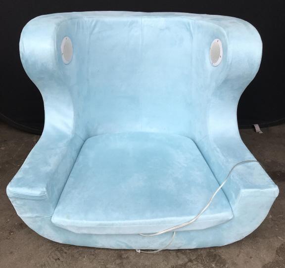 PBTEEN Blue Gamer Chair: Gamer chair has light blue tone. Piece has aux outlets and speaker. Gamer chair, lounge chair, teen chair. home furnishings game room furniture Piece measures approx. 34 inches tall 31 inches wide 29i