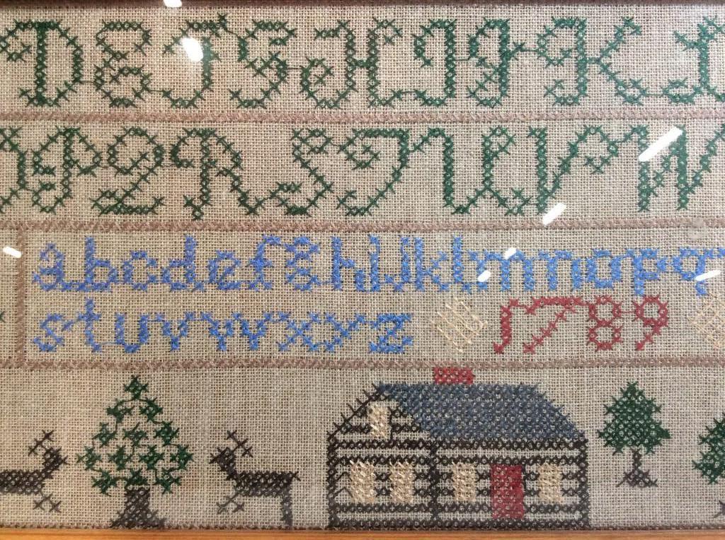 Antique Needlepoint Alphabet Sampler: Woven material, multicolor Needlepoint, Green Toned stitched capital letters, blue toned stitched lowercase, red toned date 1789. Possibly antique not inspected out of frame, animal and house in woode