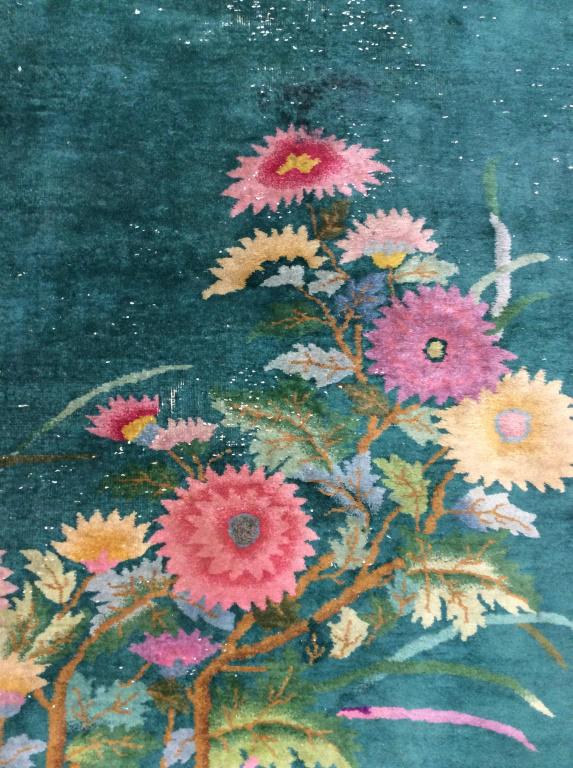 Vintage Handmade Chinese Art Deco Wool Rug: Rug is wool and handmade. Piece is vintage possibly antique. Piece has multi toned floral leaf & vine detail including tones of magenta, pink, green, cream, Slate, yellow and teal. Rug measures approx