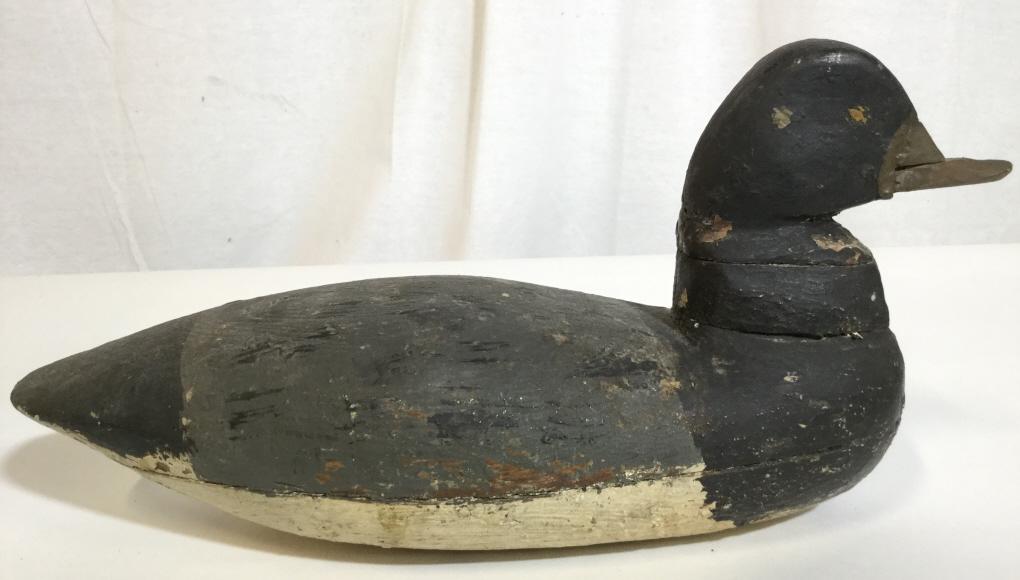 Antique Signed Folk Art Waterfowl Sculpture, c1900: This piece is an antique wooden waterfowl sculpture. The piece is Hand Painted. The piece measures approx 6.8 inches H, 3.5 inches W, and 12.5 inches long. The underside reads: circa 1900, Barnegat Ba