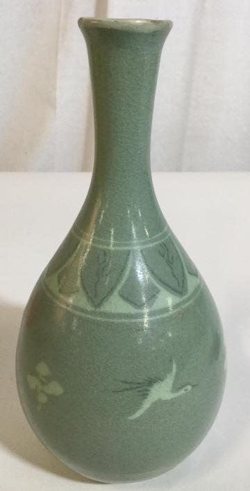 Signed Glazed Ceramic Korean Celadon Bud Vase: This piece is a Korean Bud vase. The piece is crafted from ceramic and is colored in jade celadon tones. The piece is signed on its underside, in asian characters. The piece depicts a series of cranes
