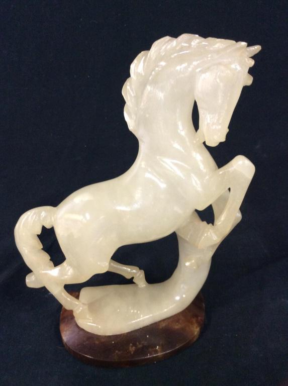 Handmade Alabaster Horse Sculpture, Italy: This piece is an Alabaster Horse Sculpture, it is mounted on a marble base. The piece originates from Italy, and is hand sculpted. The piece measures approx 9.12 inches H, and 4.75 W. label on undersi