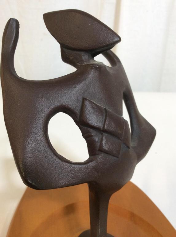 Bronze Korean Sculpture of a Woman Signed w Base: Bronze sculpture of a woman mounted on a wooden base. The piece depicts a woman in what appears to be traditional garb. The piece measures approx 7 inches H, 6 inches w, and 12.75 inches long. The pie