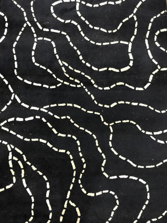 Blue & White Toned Wool carpet: Rug is wool. Piece is navy toned with white toned detail resembling tracks. Piece measures approx 76 inches long 52 inches wide. pattern carpet, area rug, home accent and decor, 6