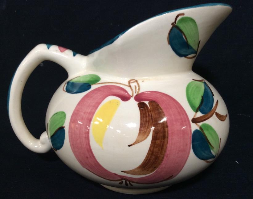 PURINTON Hand Painted Slip Ware Pottery pitcher: Marking on underside reads PURINTON SLIP WARE, beige toned ceramic pottery jug pitcher with hand painted apple and leaf design, dark cobalt blue toned trim details, some minor imperfections to glaze a