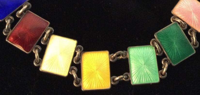 Arts & Crafts Era Multi Color Enameled Bracelet: Rectangular Design with enamel connected by round chain link, enamel has subtle radiating sun ray style pattern. Colors of blues, greens, yellows, pink & purple. Spring clasp. App 7 in. Enameled Brace