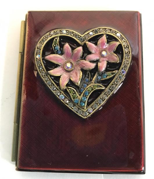 Jay Strongwater, Pocket Enamel Heart Dual Frame: Adorable Photograph Frame, hinges open, with decor Repousee Crystal And Enamel Heart Decor. Ext. burgundy color, interior royal purple enamel. Photo size app 2 x 1.5 in. Vertical. Picture Frame, Pocke