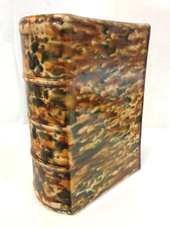 Vintage Splatter Ware Style Book Vase: Book is titled Ladies Suffering, Vintage porcelain ceramic vessel, with 3/4 inch vase opening at upper side, brown and green toned drip spatter style glaze, illegible writing on underside appears to b
