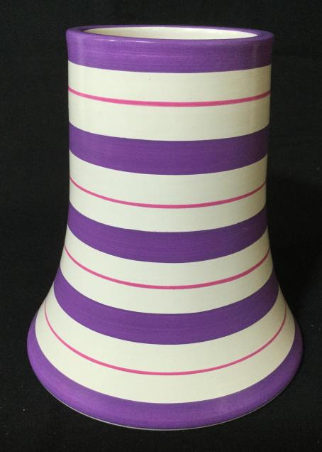 Hand Made Peruvian Decorative Earthenware Vase: This piece is a decorative vase, stoneware pottery, The piece measures approx 7 inches H, and 6.4 inches in diameter. The piece has been colored in tones of mauve, and magenta, on a white base in a st