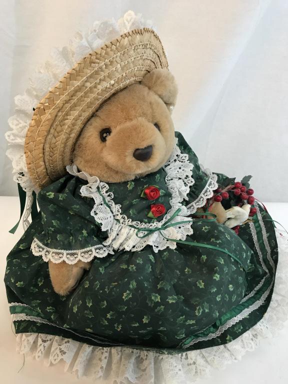 Bearly People Plush Christmas Bear: C. 1993. A fully dressed lady bear, wearing green holly dress, with straw hat & holding a dove ornament. Tulle netting under Dress fluffs up the dress bottom. Bear’s legs rotate to a sitting positio