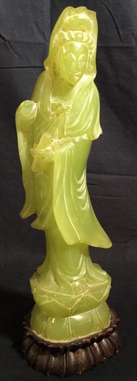 Vintage Resin Asian Guanyin Sculpture: This piece is a vintage Guanyin sculpture. The piece is cast from a green resin and mounted on a wooden base. The piece measures approx 13.12 inches H and 4.3 inches W. There is loss present on the pi