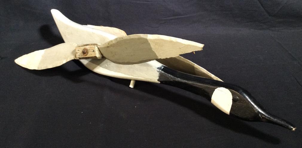 Antique Hand Painted Canadian Goose Whirligig: This piece is an antique whirligig, the piece has been painted and carved to resemble a Canadian Goose. The piece measures approx 24.75 inches long and 7.5 inches W. There is loss present on the wings