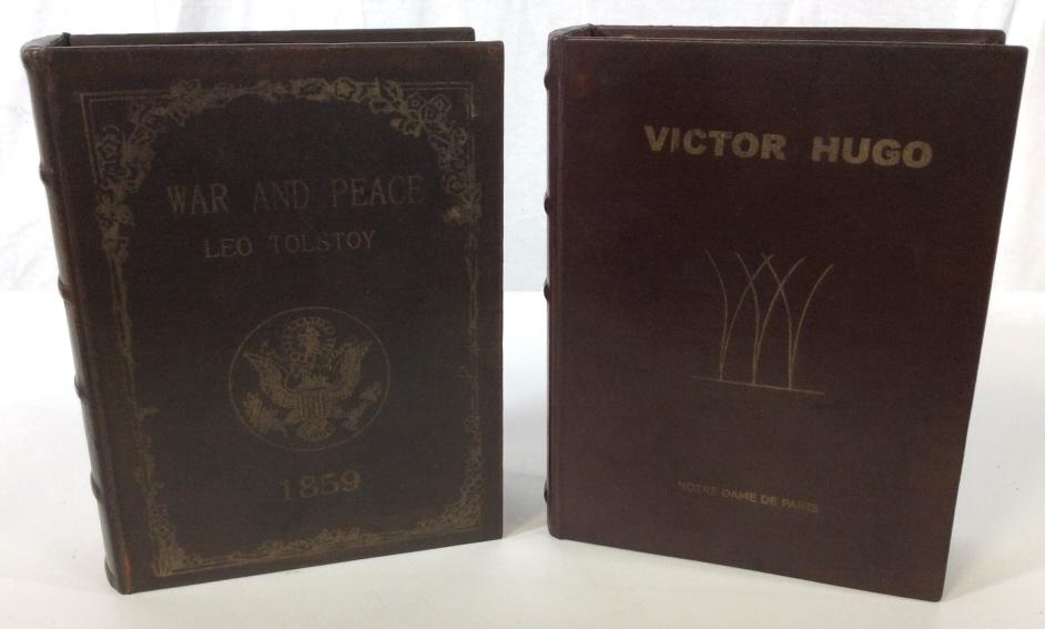 Set 2 Novel Book Form Trinket Boxes: This is a set of two Trinket boxes fashioned to resemble novels. The novels include WAR AND PEACE by LEO TOLSTOY, and NOTRE DAME DE PARIS, by VICTOR HUGO. The boxes are crafted from wood, bound in lea
