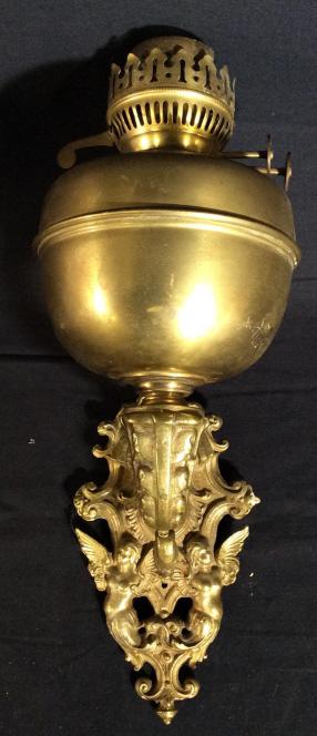 Antique JOHN SCOTT Brass Wall Sconce, England: This piece is an antique wall Sconce, manufactured by JOHN SCOTT. The piece appears to have been converted from a kerosene fueled lamp to electricity. The arm of the scones is intricately forged, a nu