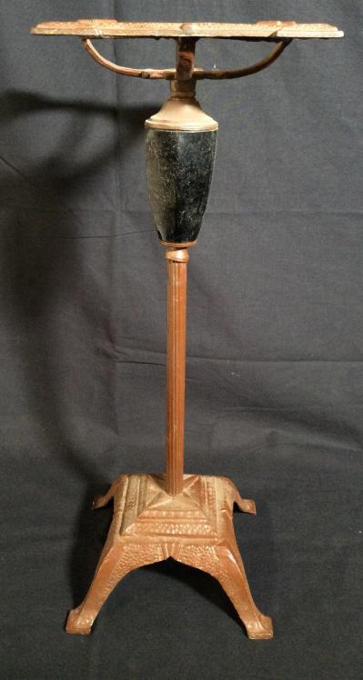 Vintage Floor Size Iron Table Base: This piece is a vintage iron multipurpose base. The piece is vintage, possibly antique. The piece has been colored a rust colored tone, a black resin inlay decorates the area beneath the mount. The pi