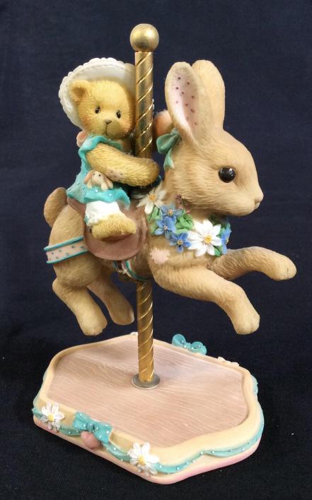 CHERISHED TEDDIES Jenelle Carousel Ceramic Figure: The label reads: Cherished Teddies, Jenelle. A registration number on the bottom reads 843/288. The number on the box reads 505579. The piece has been crafted from ceramic. The piece measures approx 5