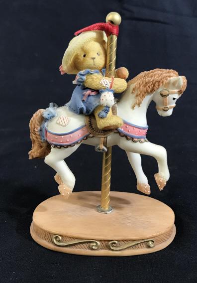 CHERISHED TEDDIES Gina Carousel Ceramic Figure: The label reads: Cherished Teddies, Gina. A registration number on the bottom reads 841/800. The number on the box and figure reads 502898. The piece has been crafted from ceramic. The piece measures 
