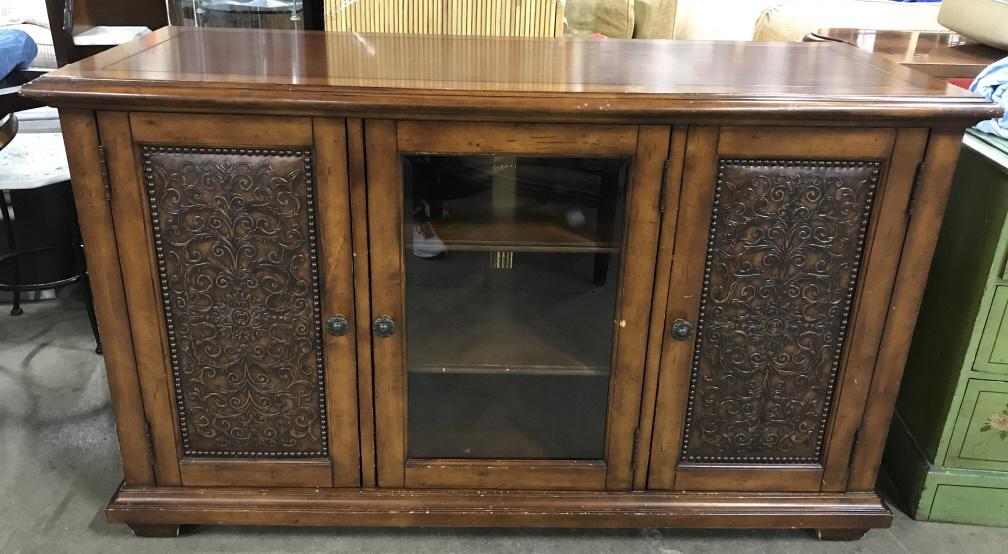 Vintage Wooden Credenza Sideboard: Vintage Wooden Credenza Sideboard Buffet with a center glass door flanked by two side doors with scroll and leaf faux leather panel design surrounded by nailhead trim, measures approximately 60 inches