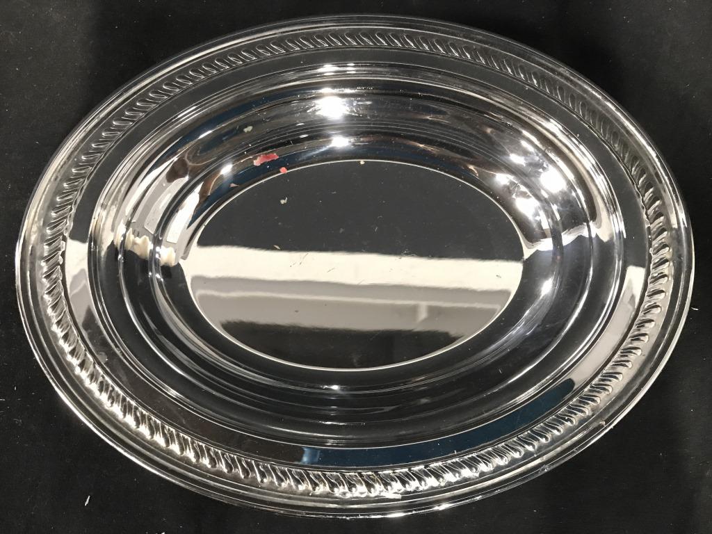 Pair Silver Toned Oval Shaped Metal Bowls: Bowls are metal and silver toned. Pieces are both oval shaped. Piece measures approx 12 inches long 9.5 inches deep, 1.5 inches tall. tableware serving dishes, bowls, platters. 6