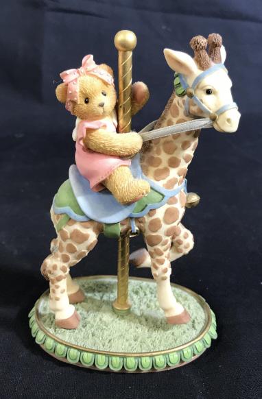 CHERISHED TEDDIES Flossie Carousel Ceramic Figure: The label reads: Cherished Teddies, Flossie. A registration number on the bottom reads 9H8/716. The number on the box and figure reads 589950. The piece has been crafted from ceramic. The piece measur