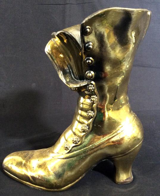 ARTBRASS METAL CO Vintage Brass Boot Statue: This piece is a vintage brass statue/vessel. The piece is produced by ARTBRASS METAL CO LTD. The piece is cast to resemble a Victorian Style button up heeled boot. The piece measures approx 9.75 inche