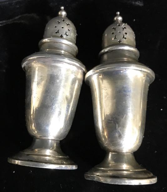 Lot 4 Vintage Matching SS Candlesticks & Shakers: Tapered candlestick holders, Sterling Silver and weighted, Marked on underside ‘Sterling, cement filled’. Measure 3 x 3 in. App 3/8 in. deep for placement of candle. Pair Sterling a Silver Salt & 