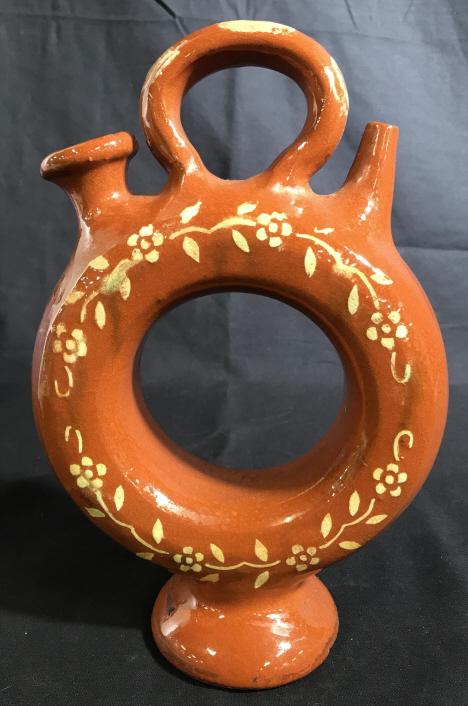 Vintage Glazed Handmade Earthenware Vessel: This is a glazed earthenware vessel, the piece is vintage. The piece is Handmade and features hand painted floral decorations. The piece has been shaped into a loop, The piece measures approx 10.6 inc