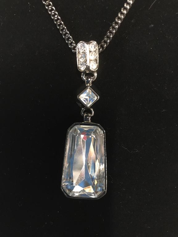 GIVENCHY Cocktail Rhinestone Necklace, Signed: Dominant pendant solitaire rhinestone, 1 1/8 in. x 5/8 in. GIVENCHY logo on underside and on box clasp. Elaborate crystal bail, double channel set row and separate diamond shape. Rhodium Grey Tone Met