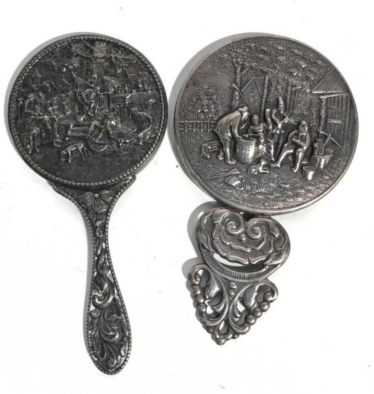 Pair Vintage Victorian Style Hand Mirrors: These are a pair of Victorian style hand mirrors. Each mirror features a different Relief on their backs, as well as intricately Patterned handles. The largest mirror measures approx 4.5 inches H and 
