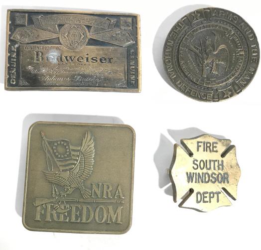 Lot 4 Vintage Metal Belt Buckles: This is a lot of 4 vintage belt buckles. They each feature a different design on the face of the buckle. The largest piece measures approx 3 inches H and 3 inches W. The pieces show some signs of wear