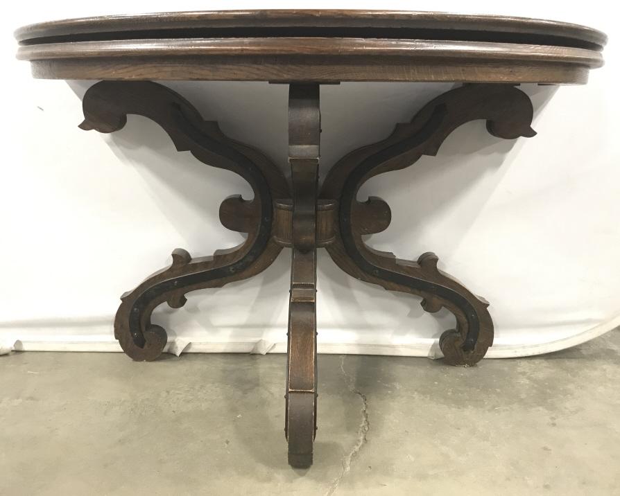 Antique Wood And Iron Pedestal Card Table Demilune: Antique Circular Chestnut Wood Card Table with carved scroll legged wood and iron base and forged metal hinges that transform table into a Demilune table. Measures approximately 48 inches in diameter 