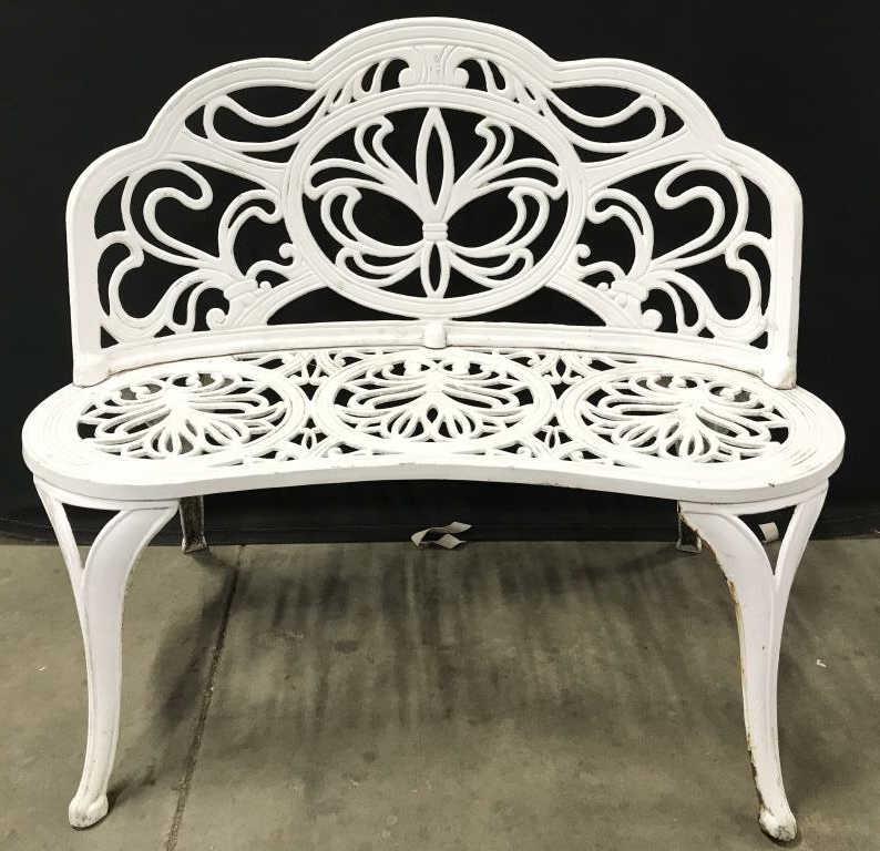 Outdoor White Toned Metal Garden Bench: Garden bench is white toned. Piece contains c and s Scroll Detail. Bench has backrest. Piece has 4 legs. Appears to be vintage. Garden bench, outdoor bench, white bench, weathered bench, vintage bench