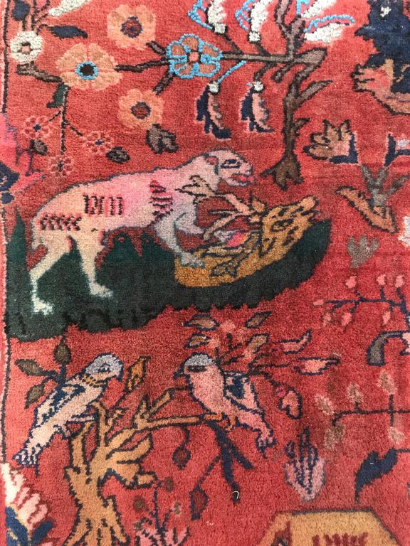 Vintage handmade Animal Detailed Wool Rug: Rug is wool and handmade. Piece is vintage. Contains multi toned detail depicting various animals including birds, deer, wolf and others along with floral detail. Rug has short fringes. Measures appro