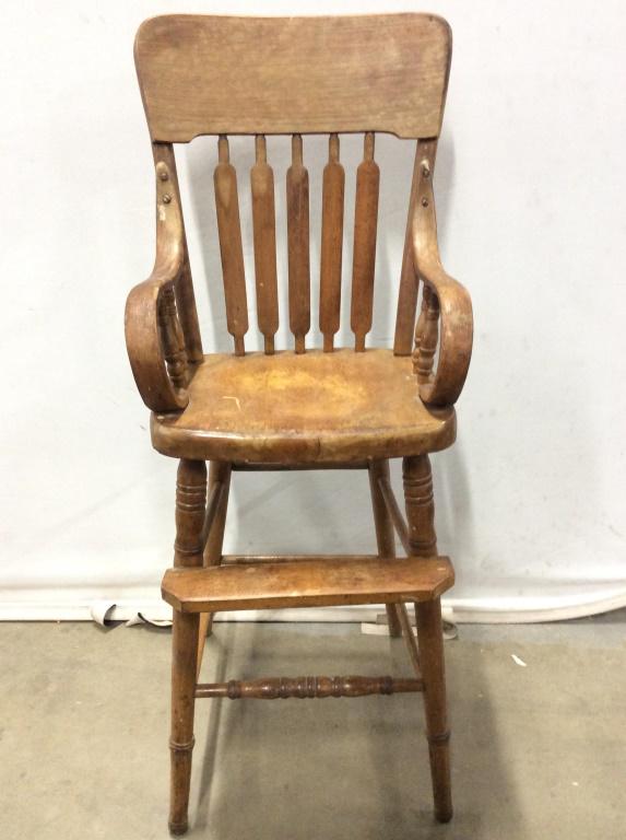 Vintage Carved Wooden Children's High Chair: Chair is wooden. Piece possibly has hand carved elements. Contains c curve style backrest, carved wooden stretchers & footrest. Piece is possibly antique. High chair, vintage high chair, wooden high c