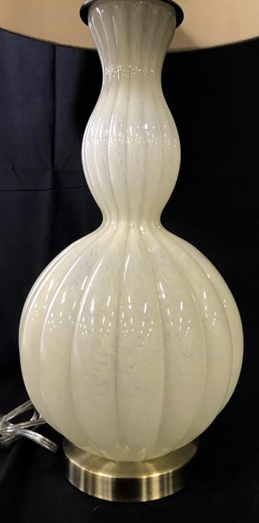 Mid Century Modern Style Speckled Art Glass Lamp: Oversized drum shade, 16 in. diameter. Brass base, glass pedestal lamp. Speckled cream color with a soft flow. Twist switch. Needs finial. Shade is a thick cardboard stock, minor spot discoloration. A