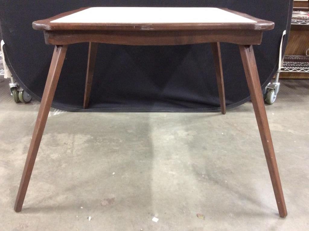 Vintage Folding Leg Game Table: Center of table has cream toned top, leather style. Structure is chocolate toned. Piece contains 4 folding legs. Game table, folding table, wooden folding table, wooden game table, vintage game table.