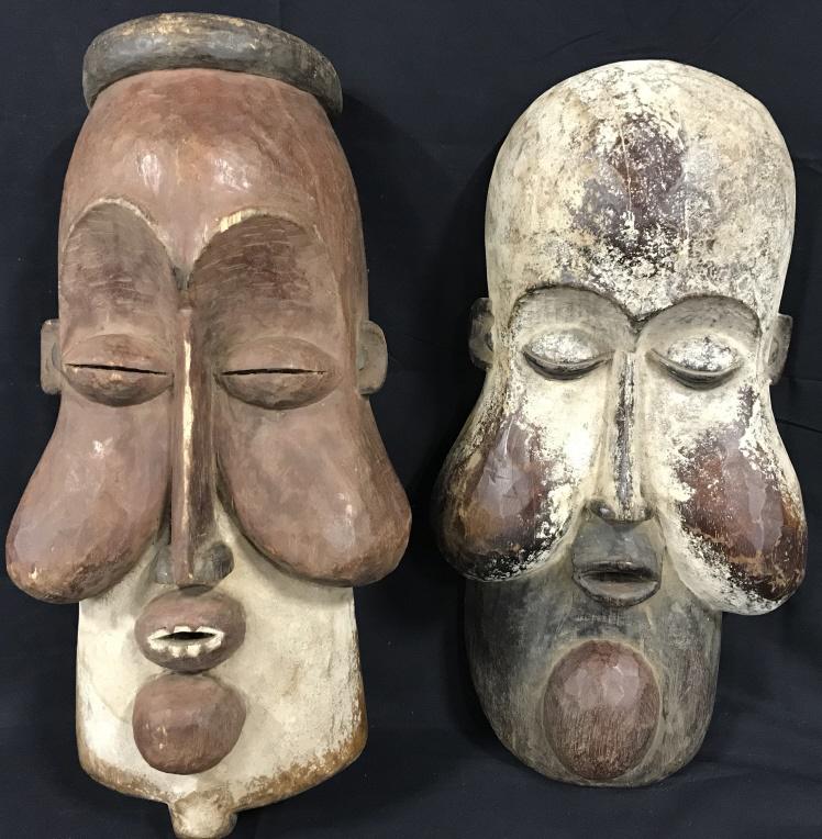 Pair Udumdu KONGO Wooden Masks, Zaire: This is a pair of large hand carved wooden masks, the pieces originate from Zaire, of central Africa. Each Mask has three holes, two can be found on the upper half of the left and right side of the ma