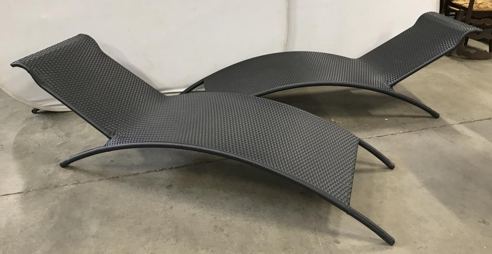 Pair ZUO BIARRITZ Chaise Lounge: Zuo Biarritz Black Toned Wicker Chaise Lounge with minimalistic arch form design, constructed of UV treated synthetic weave and reinforced aluminum frame. Measures approx 25 inches W x 82.5"p inches D