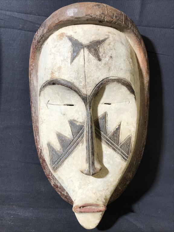 Pair Wooden White FANG Mask, Gabon: This is a pair of wooden mask, the pieces are hand carved, and originate from Gabon of Central Africa. The pieces are colored in white pigments, possibly with kaolinite, and have elongated facial feat